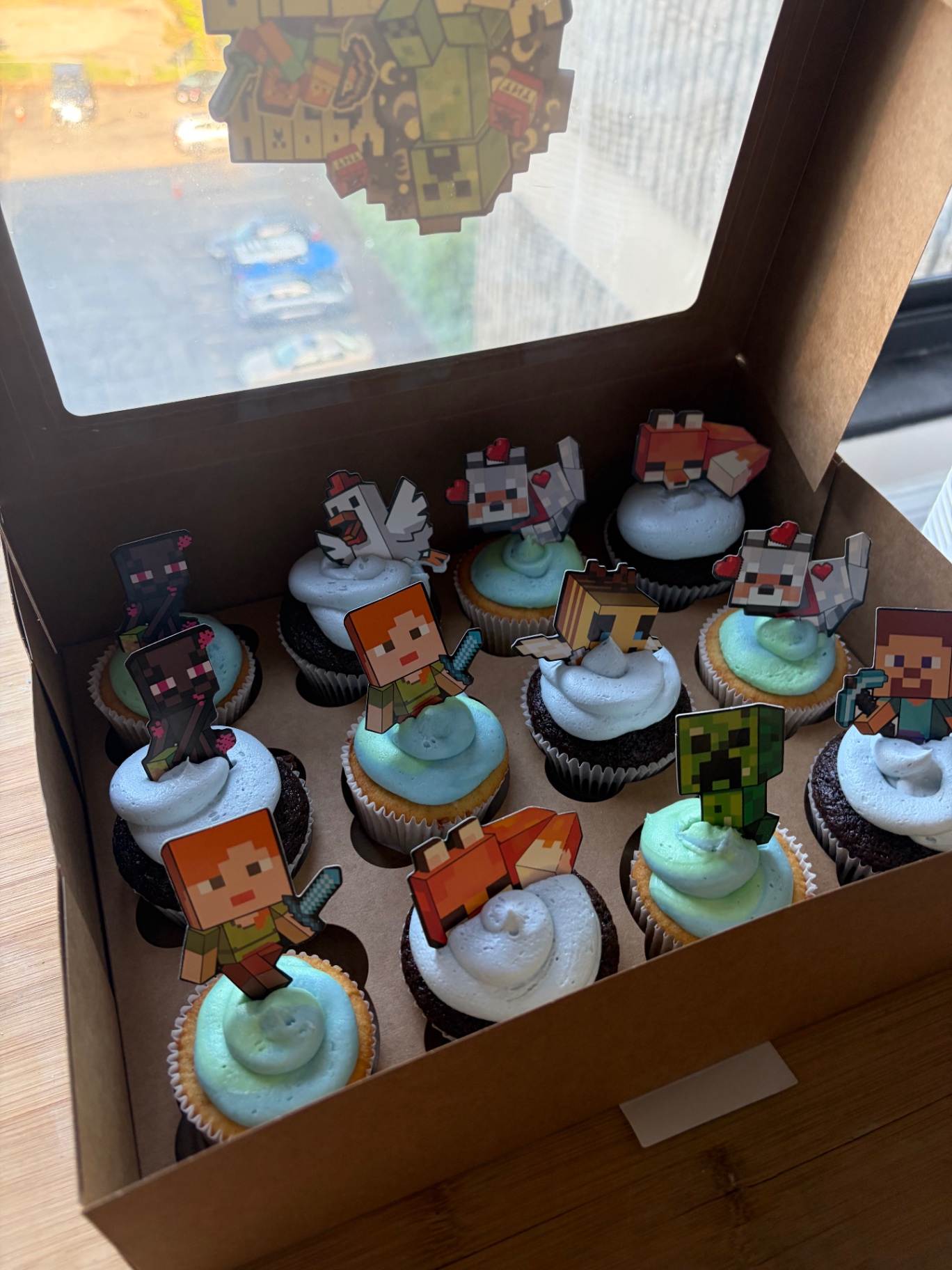 Cupcakes with pastel blue frosting and character toppers